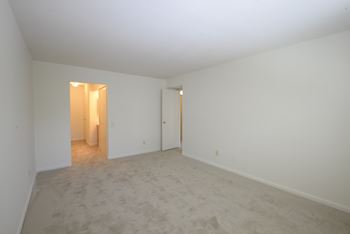 Bedroom with white walls and carpet at Charlesgate Apartments, Maryland, 21204